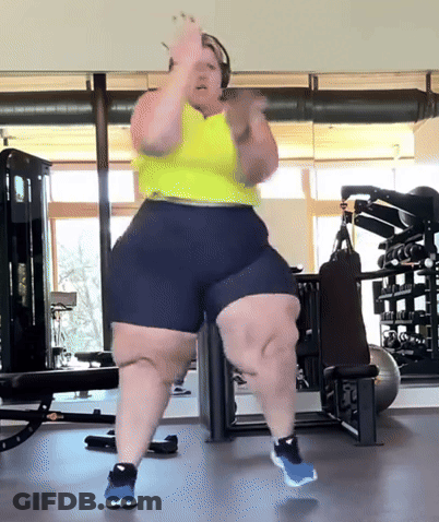 Woman Dancing In Gym Wearing Shorts And Yellow Tank Top GIF