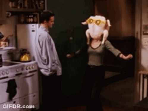 Woman Dancing In Kitchen With Turkey On Head GIF