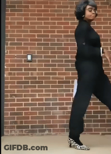 Woman Dancing In Leopard Shoes Near Brick Wall GIF