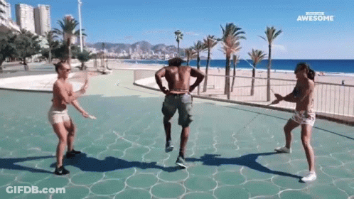 Woman Dancing In Park, Man Holding Drink GIF