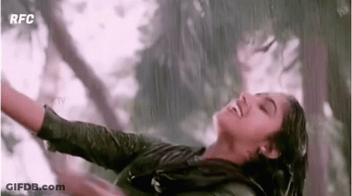 Woman Dancing In Rain With Arms Outstretched Smiling GIF