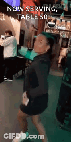 Woman Dancing In Restaurant Saying Now Serving Table 50 GIF