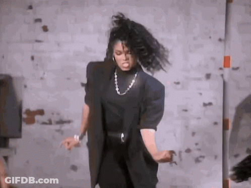 Woman Dancing In Room With Brick Wall GIF