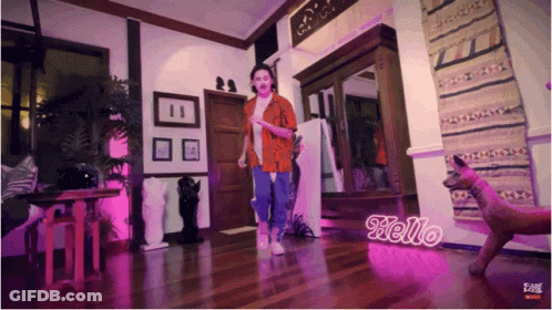 Woman Dancing In Room With Hello Sign GIF