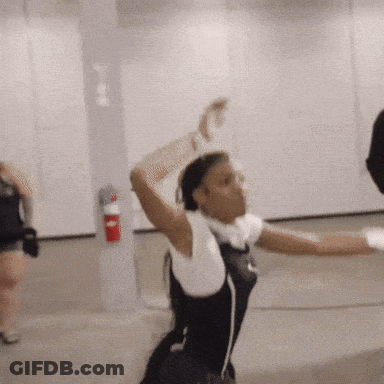 Woman Dancing In Room With Red Fire Extinguisher GIF