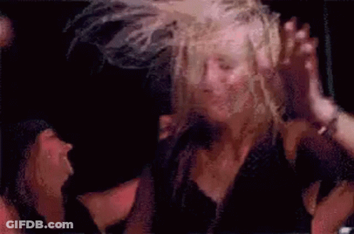 Woman Dancing In Windy Crowd GIF