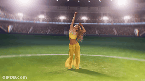 Woman Dancing On Soccer Field With Arms In Air GIF
