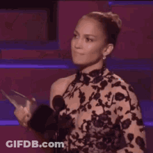 Woman Dancing On Stage Holding Cell Phone GIF