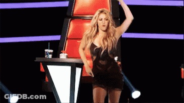 Woman Dancing On Stage In Front Of Red Chair GIF