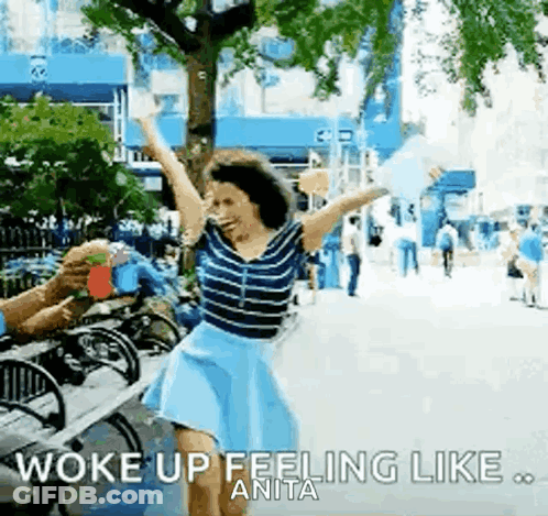 Woman Dancing With Arms Up Man Holding Drink GIF