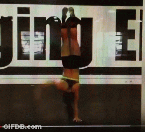 Woman Doing Handstand In Front Of Jinue Sign GIF