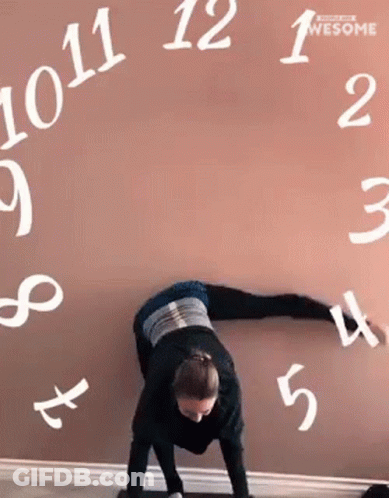Woman Doing Handstand In Front Of Numbers Wall GIF