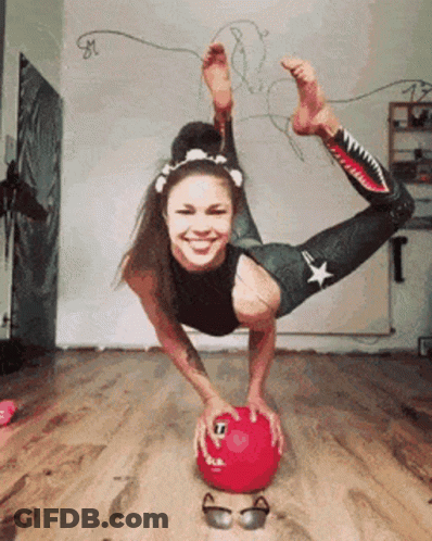 Woman Doing Handstand On Red Ball GIF