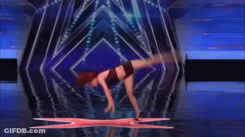 Woman Doing Handstand On Stage With X GIF