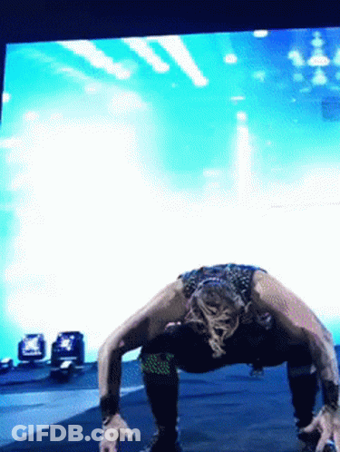 Woman Doing Push Ups In Front Of Blue Background GIF