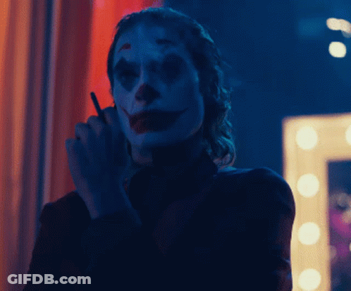 Woman Dressed As Clown Smoking GIF
