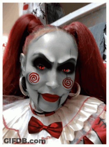 Woman Dressed As Scary Clown With Red Hair And Red Eyes GIF