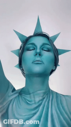 Woman Dressed As Statue Of Liberty Eyes Closed GIF