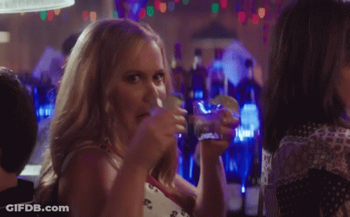 Woman Drinking And Eating Taco In Bar GIF