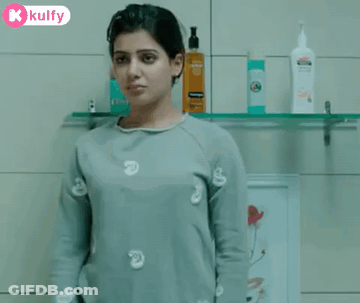 Woman Drinking From Glass In Bathroom GIF