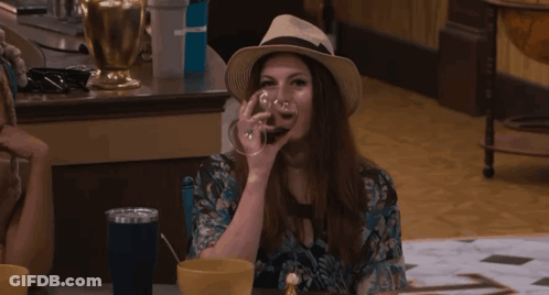 Woman Drinking From Glass With Hat GIF