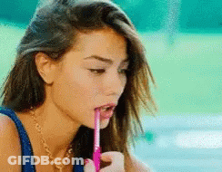 Woman Drinking From Pink Straw With Pen GIF