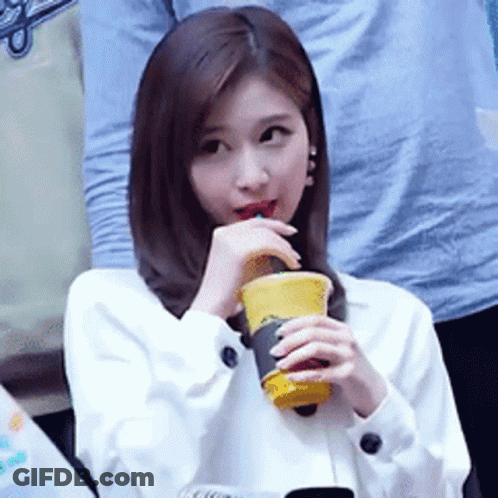 Woman Drinking From Yellow Cup GIF