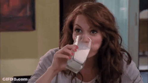 Woman Drinking Glass Of Milk At Table GIF