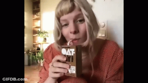 Woman Drinking Oat Milk Through Straw GIF