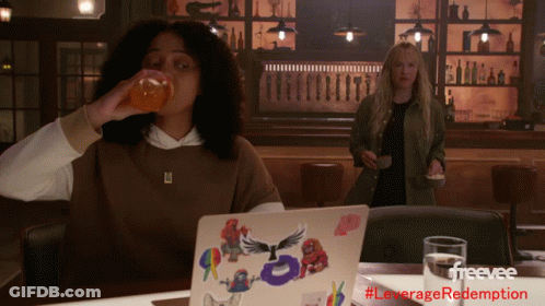Woman Drinking Orange Juice Next To Laptop GIF