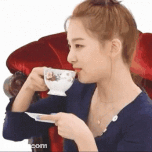 Woman Drinking Tea In Red Chair GIF