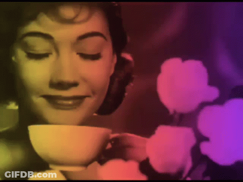Woman Drinking Tea With Flowers GIF