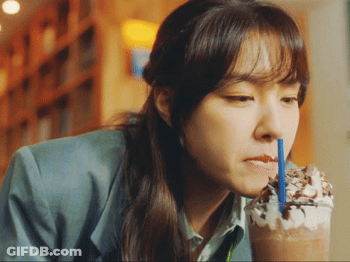 Woman Drinking Through Blue Straw GIF