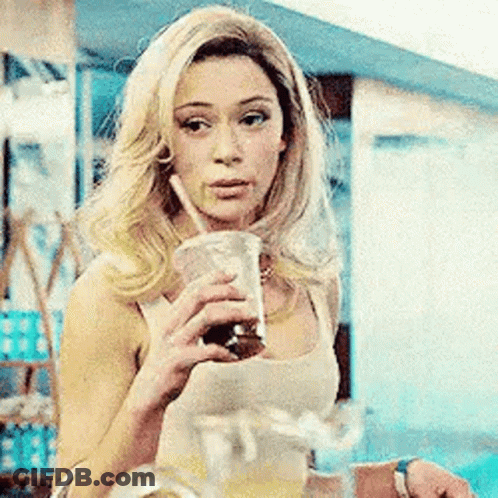 Woman Drinking Through Straw Holding Pitcher GIF
