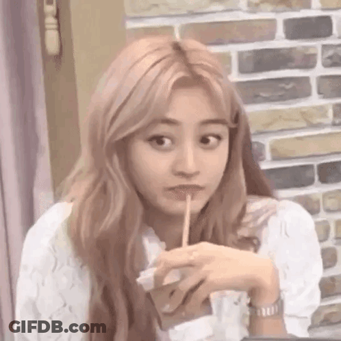 Woman Drinking With Straw At Table GIF