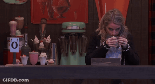 Woman Drinks From Glass Under 0 Degrees Sign GIF