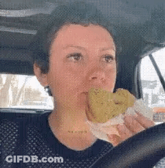 Woman Driving Car Eating Fried Sandwich GIF