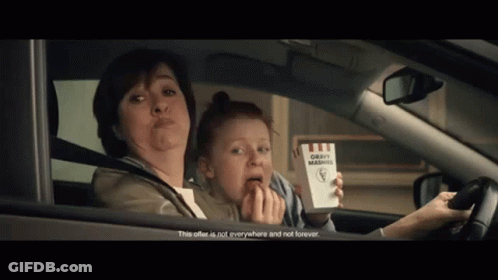 Woman Driving Car With Child Holding Box Of Gravy Mashed Potatoes GIF