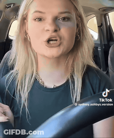 Woman Driving Car With TikTok Watermark GIF