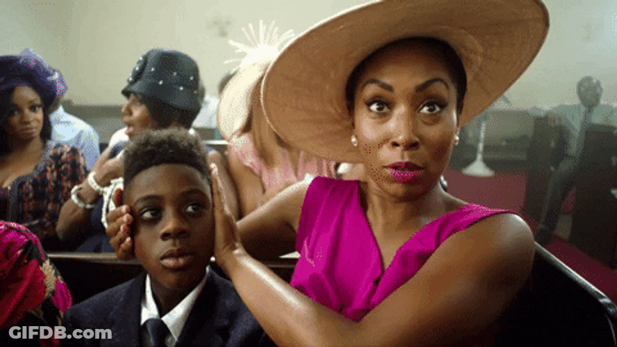 Woman Ear Plugs Her Son Inside Church GIF