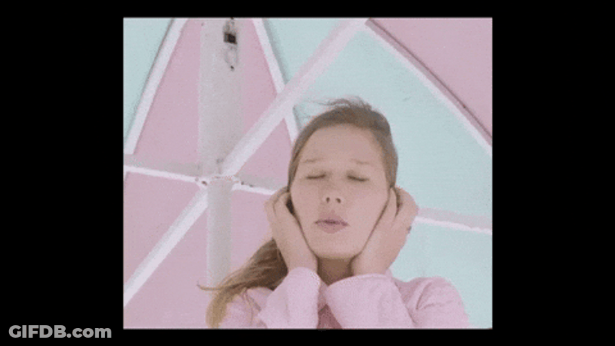 Woman Ear Plugs While Singing GIF