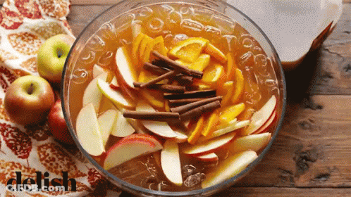 Woman Eating Apple From Man's Hand On Couch GIF