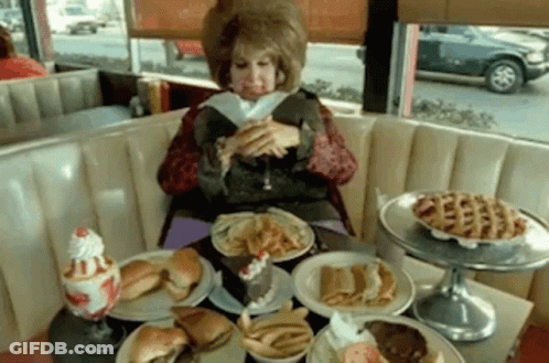 Woman Eating At Diner Table GIF