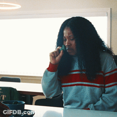 Woman Eating Broccoli At Table GIF