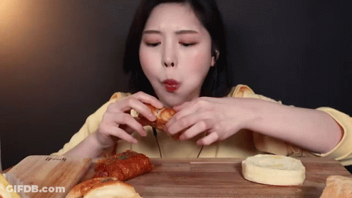 Woman Eating Bunch Of Bread GIF