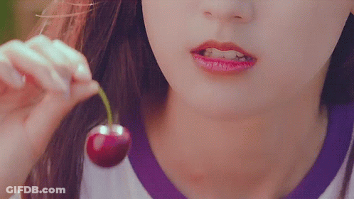 Woman Eating Cherry With Green Stem GIF
