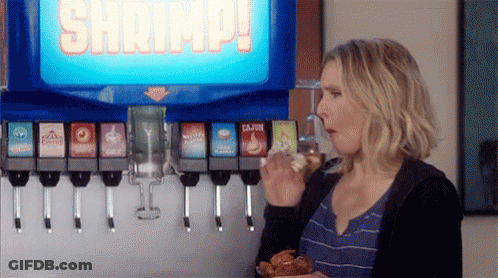 Woman Eating Chicken And Drinking Soda At Soda Machine GIF