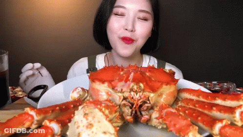 Woman Eating Crab Eyes Closed GIF