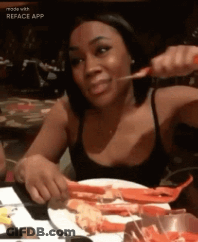 Woman Eating Crab Legs At Table GIF