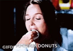 Woman Eating Donut Saying Mmmmm Donuts GIF